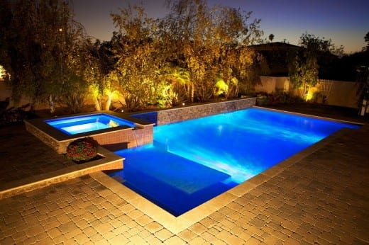 backyard swimming pool at night