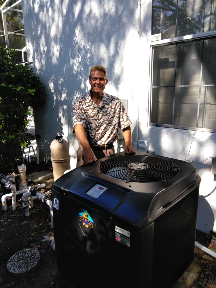 florida pool owner standing next to oasis heat pump pool heater